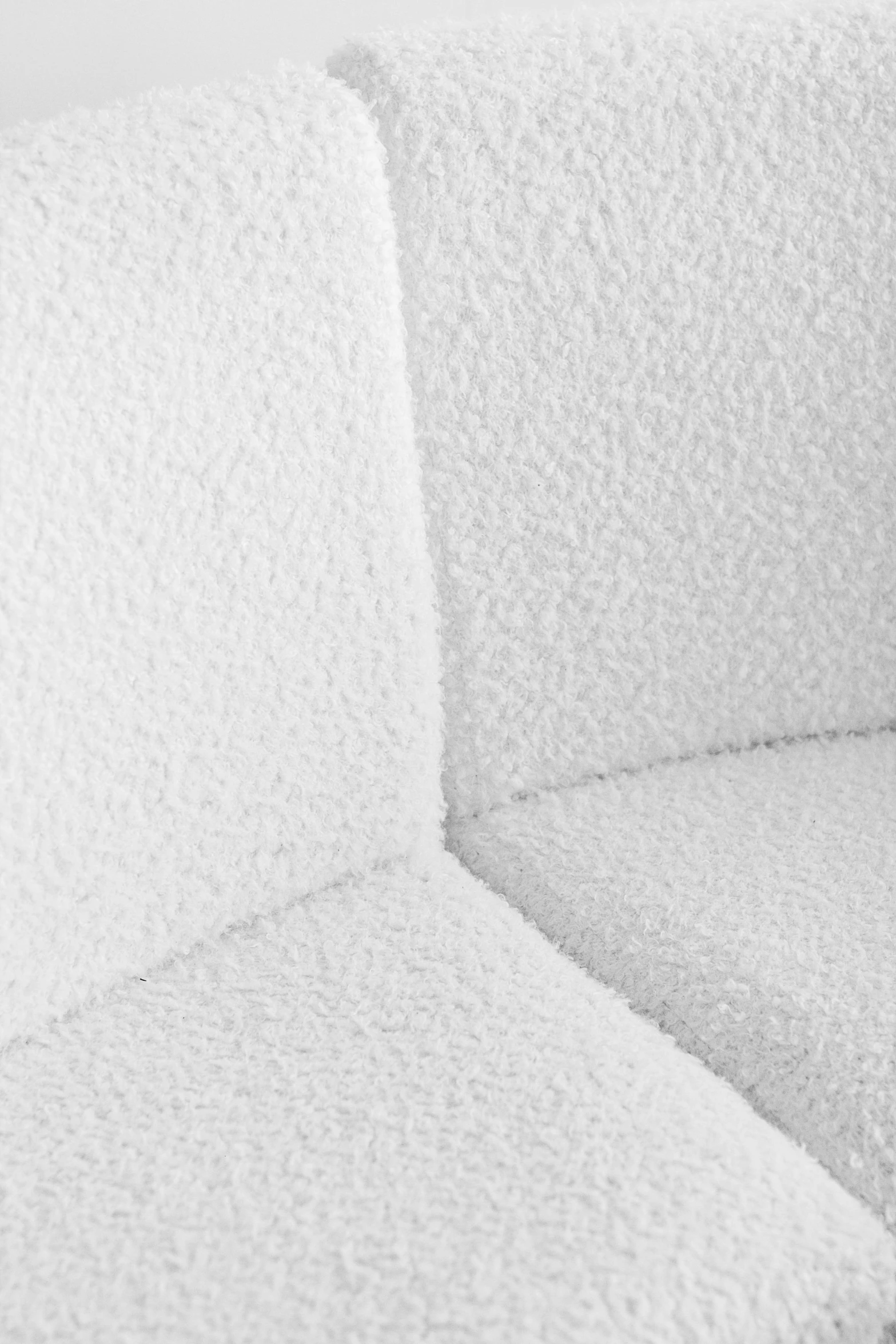 a close up of a white couch cushion