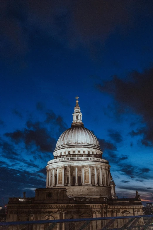 the dome is white and surrounded by many clouds