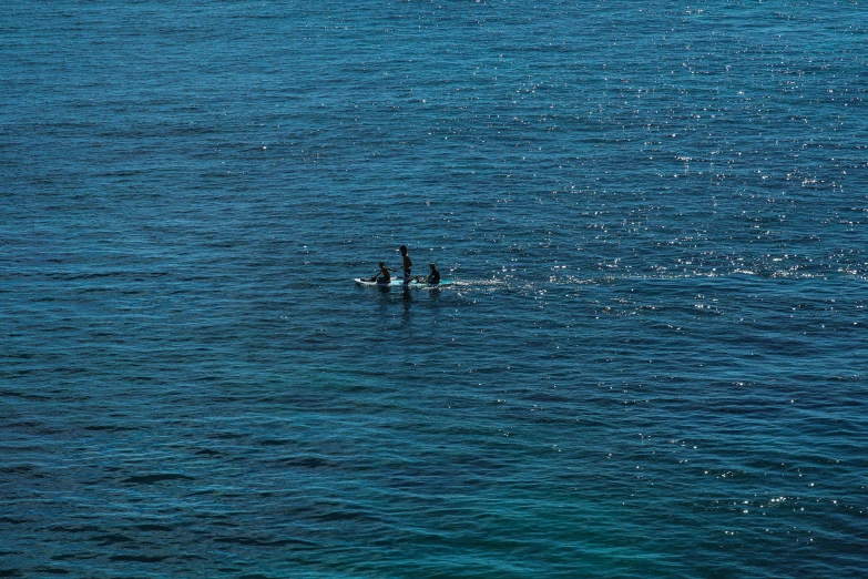 two people are out in the ocean fishing