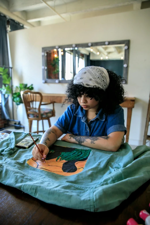 a woman at a table with a picture on it