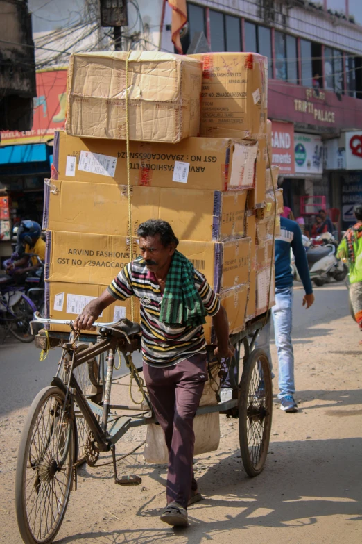 a person riding a bike with some boxes