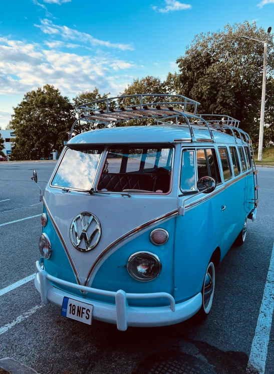 a blue and white volkswagen bus parked on pavement