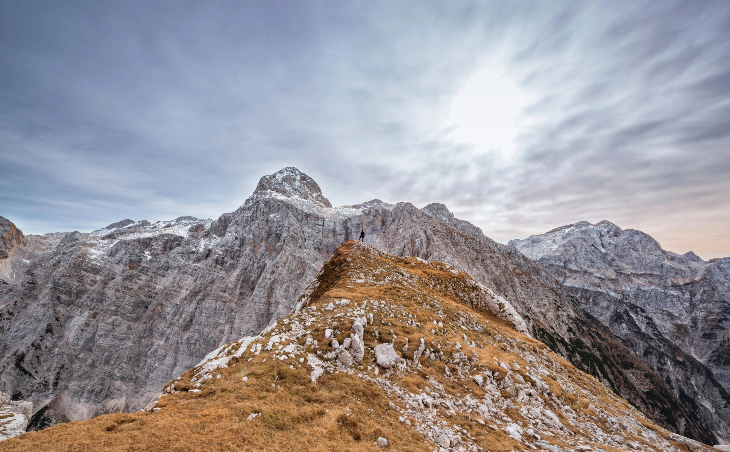 a person on a mountain slope climbing up a slope