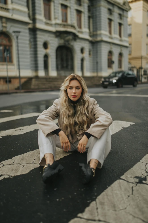 a woman sitting on the floor posing for a po