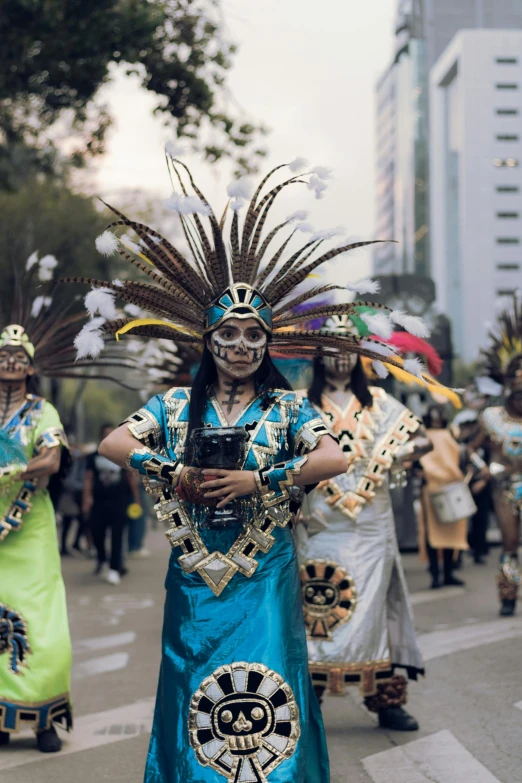 a native american dancer dressed in blue and silver