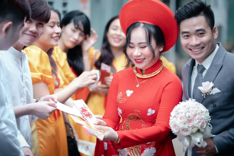 young people in formal wear and hats taking pictures