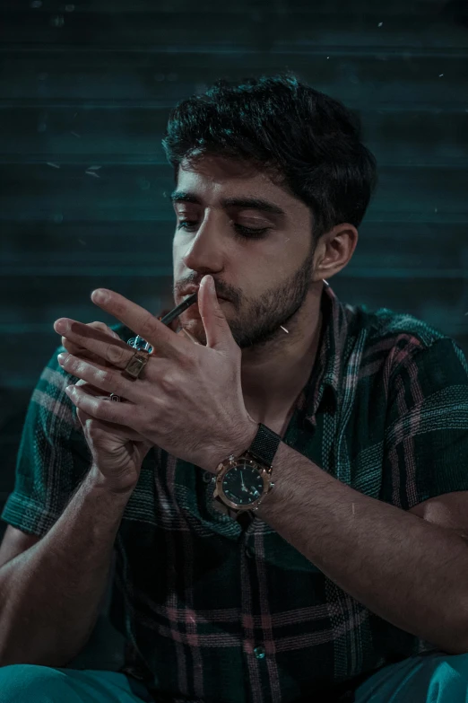 a man sitting on the floor and smoking a pipe