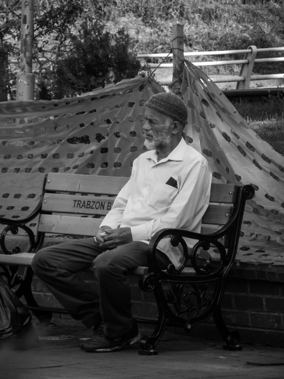 an older couple sits on a bench at the park