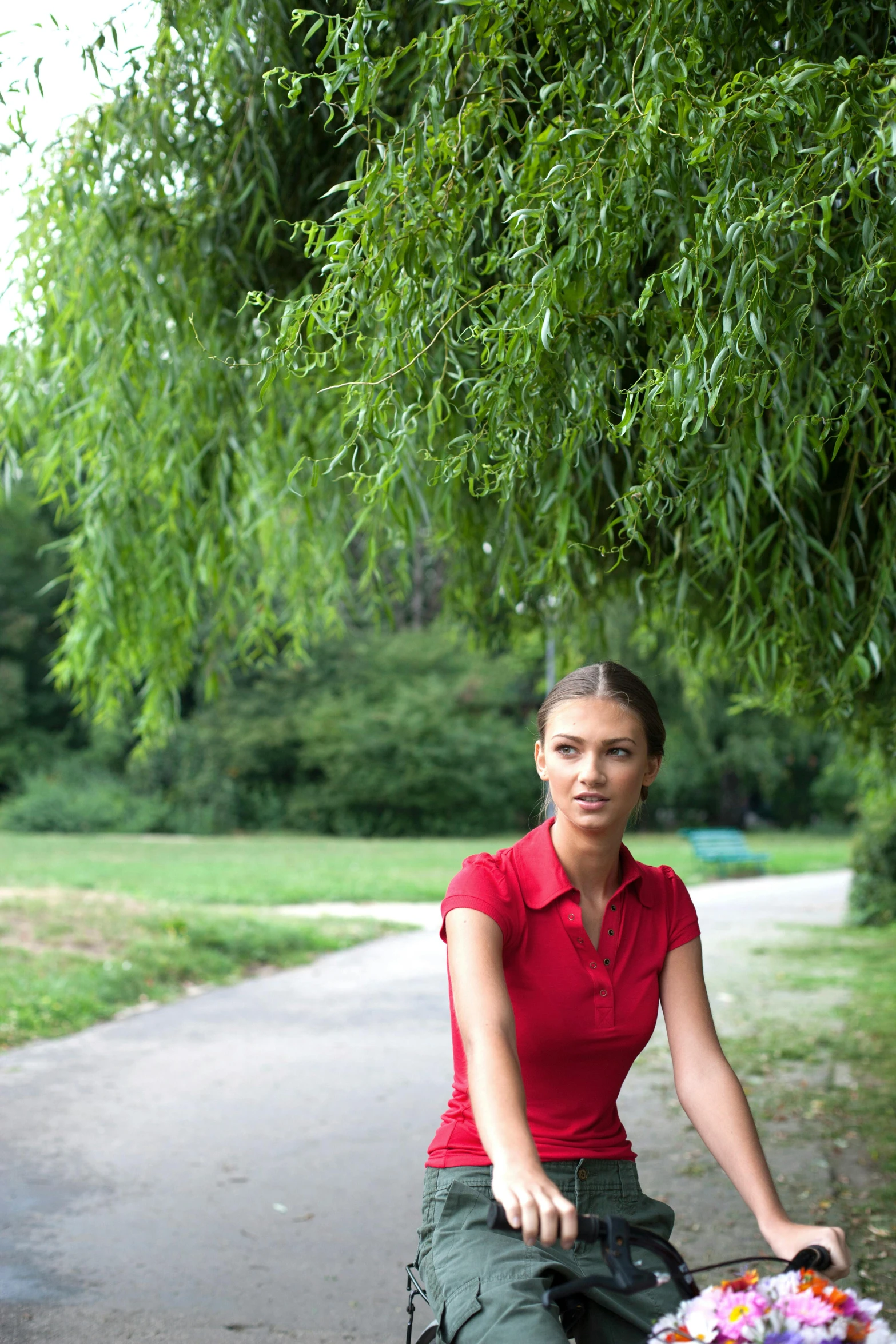 a woman is riding a bike in a park