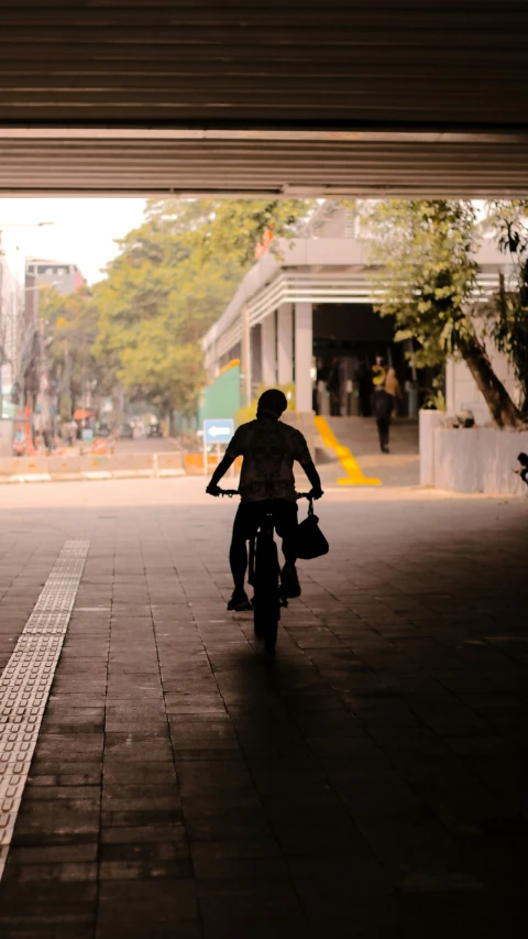 a man is riding a bicycle in an underpass