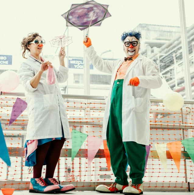 a group of people dressed as clowns hold up umbrellas