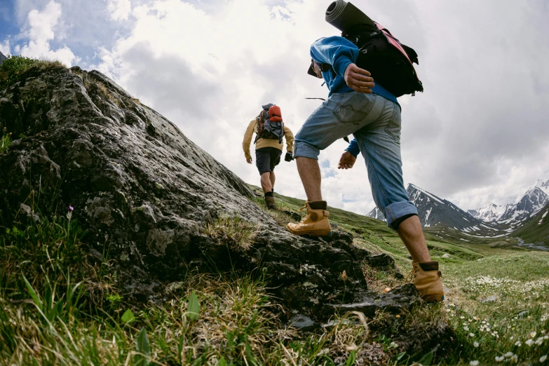 two people standing next to each other on a hill