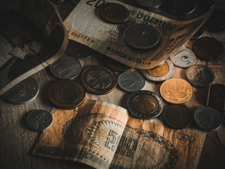 several coins and an open book on a table