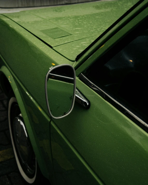 the side mirror of a car is reflecting it's image