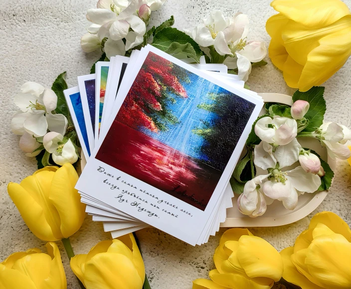 a group of cards sitting on top of yellow flowers