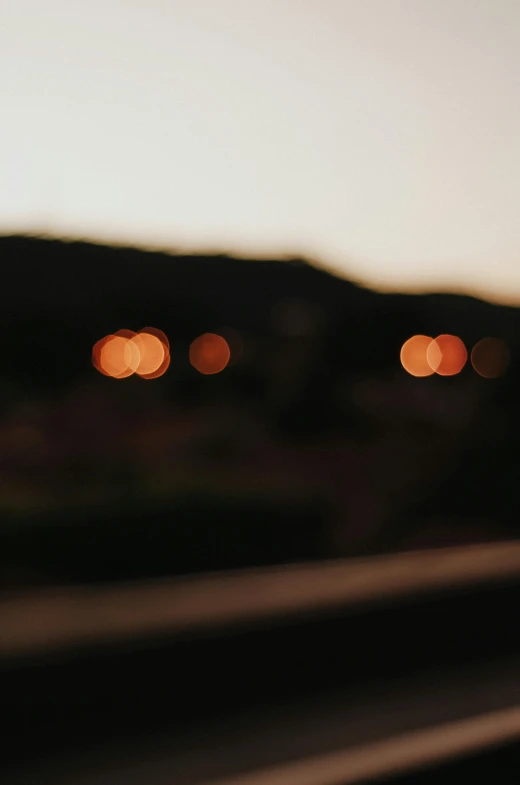 a stop sign with blurry city lights in the background