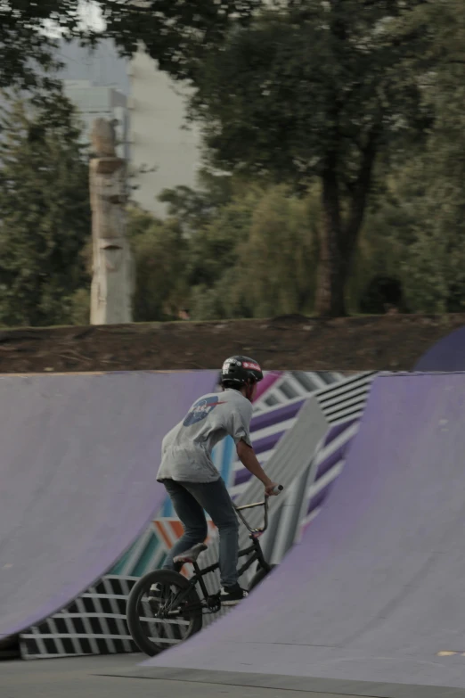 a person riding a bike up a ramp