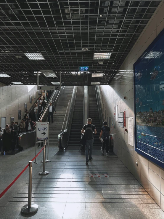 a po taken of several people walking along a subway platform
