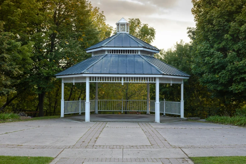 gazebo in a park with grass and trees