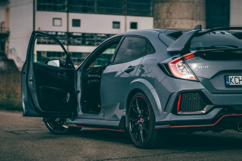 the grey honda civic rs hatchback has an open door