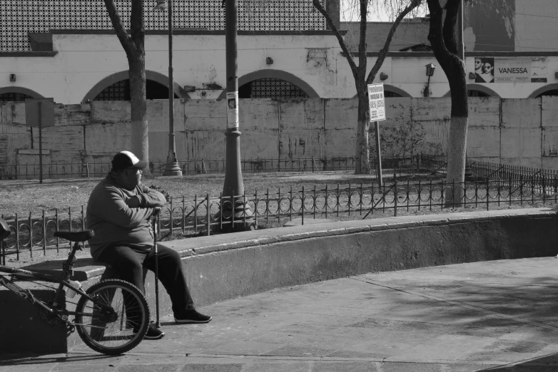 a man is sitting on his bicycle as he talks on the phone