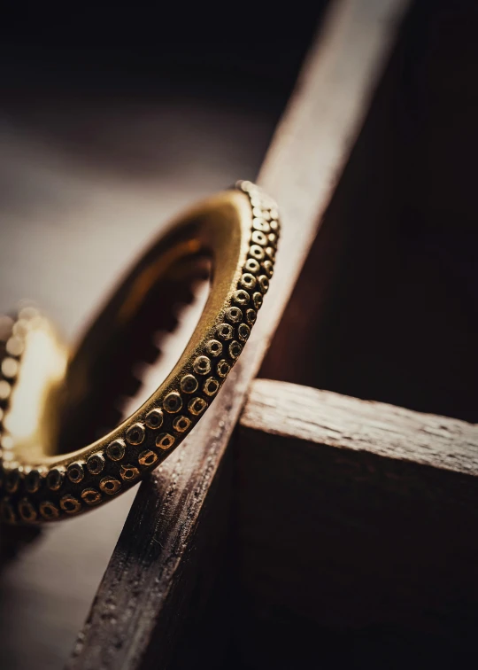 close up of two gold wedding rings on wood