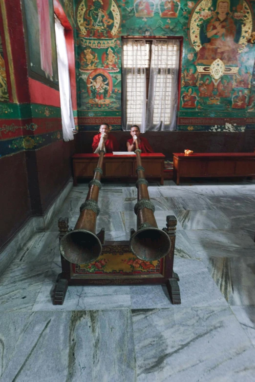 two antique cannon heads sitting on top of a wooden table