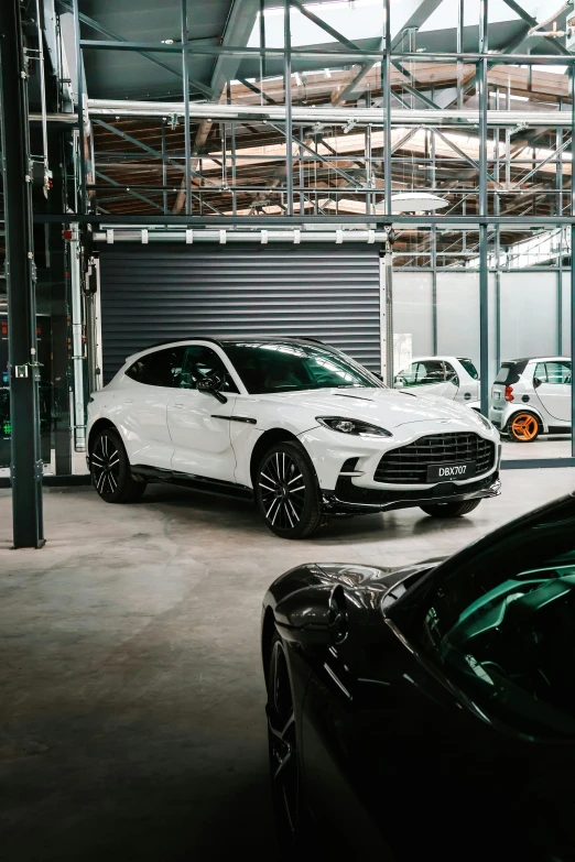 two cars parked inside of a garage next to a closed door