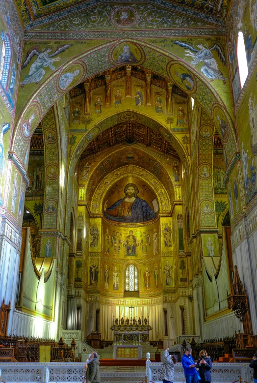 a church with people praying in front of the alter