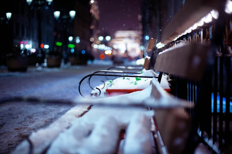 a long bench with a broken side on the side walk