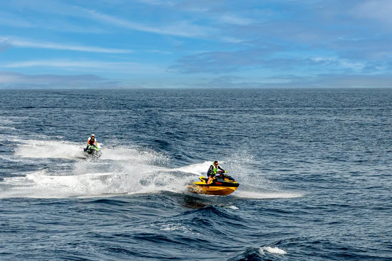 a couple of men on water skis going through the water