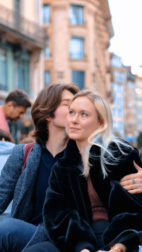 two women sitting on a bench with each other