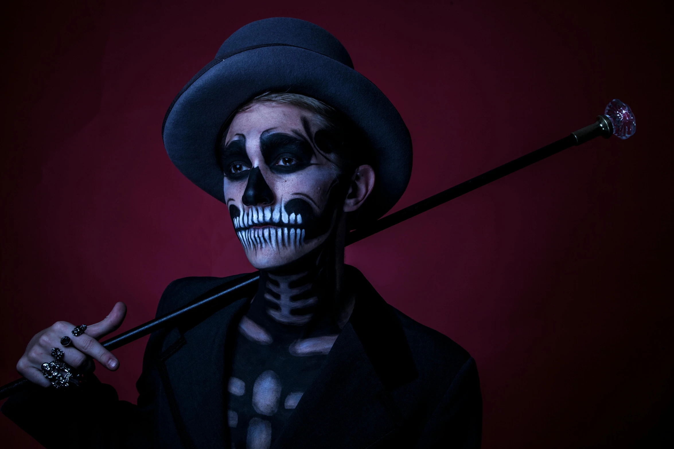 a woman with a black mask and skeleton makeup