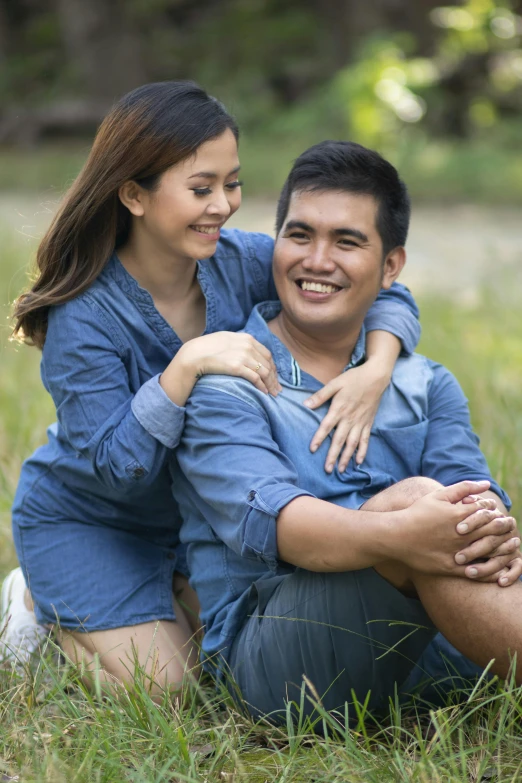 a man holding a woman while she smiles