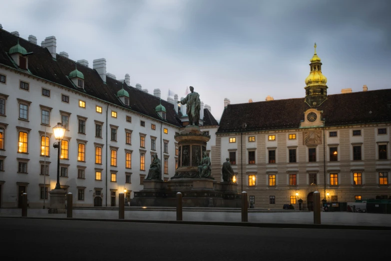 a big building with some lights on and the clock on