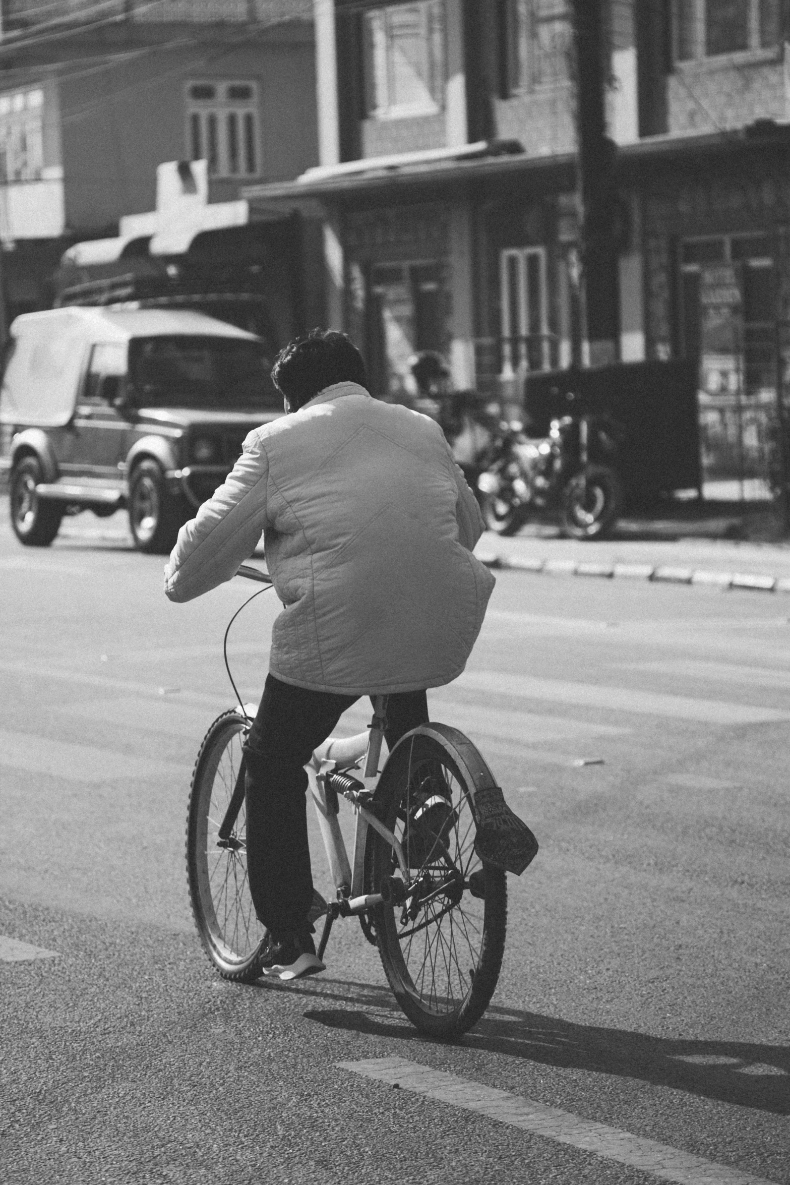 a person riding on the back of a bicycle