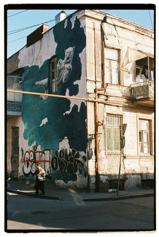 a street corner with graffiti and an old building