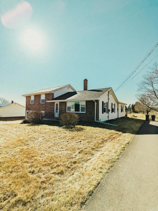 the front of a house with a sign in front