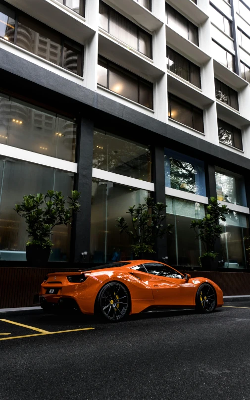 a luxury orange car parked on the side of the road