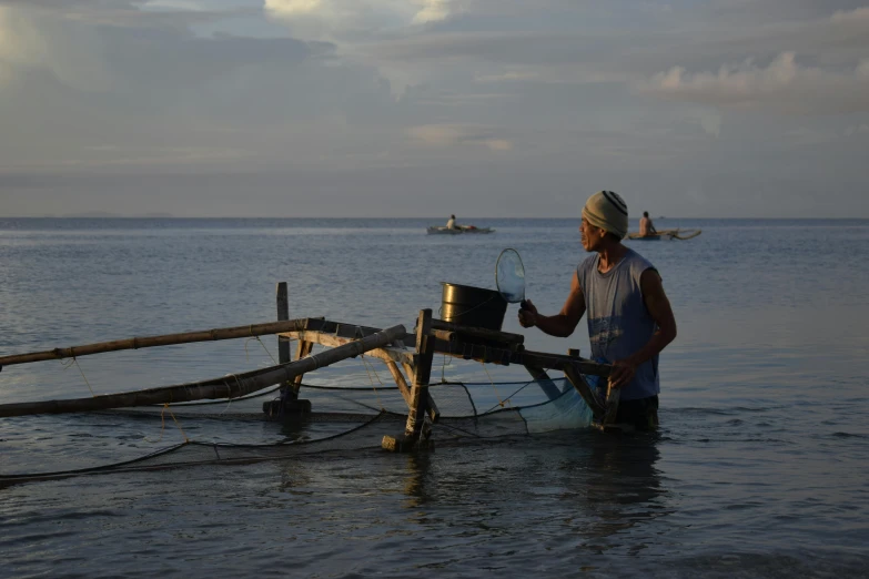 the fisherman is washing his catch in the water