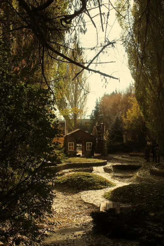 an outdoor path with leaf covered trees and an old home