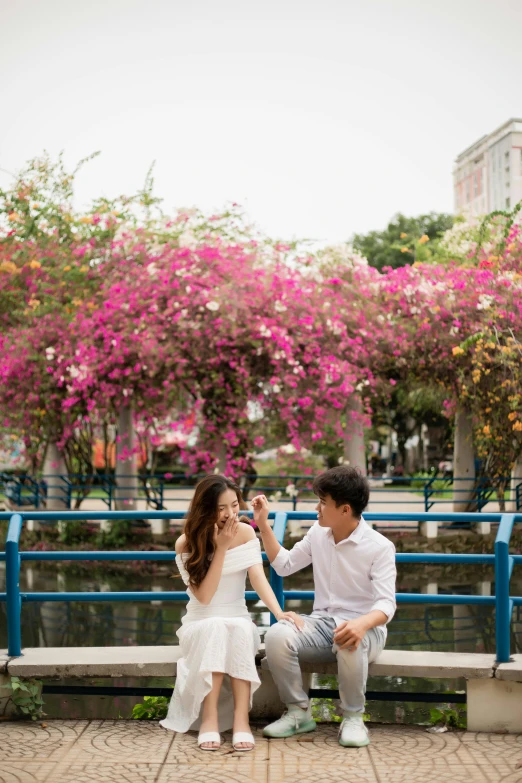 a man and a woman are sitting on a bench