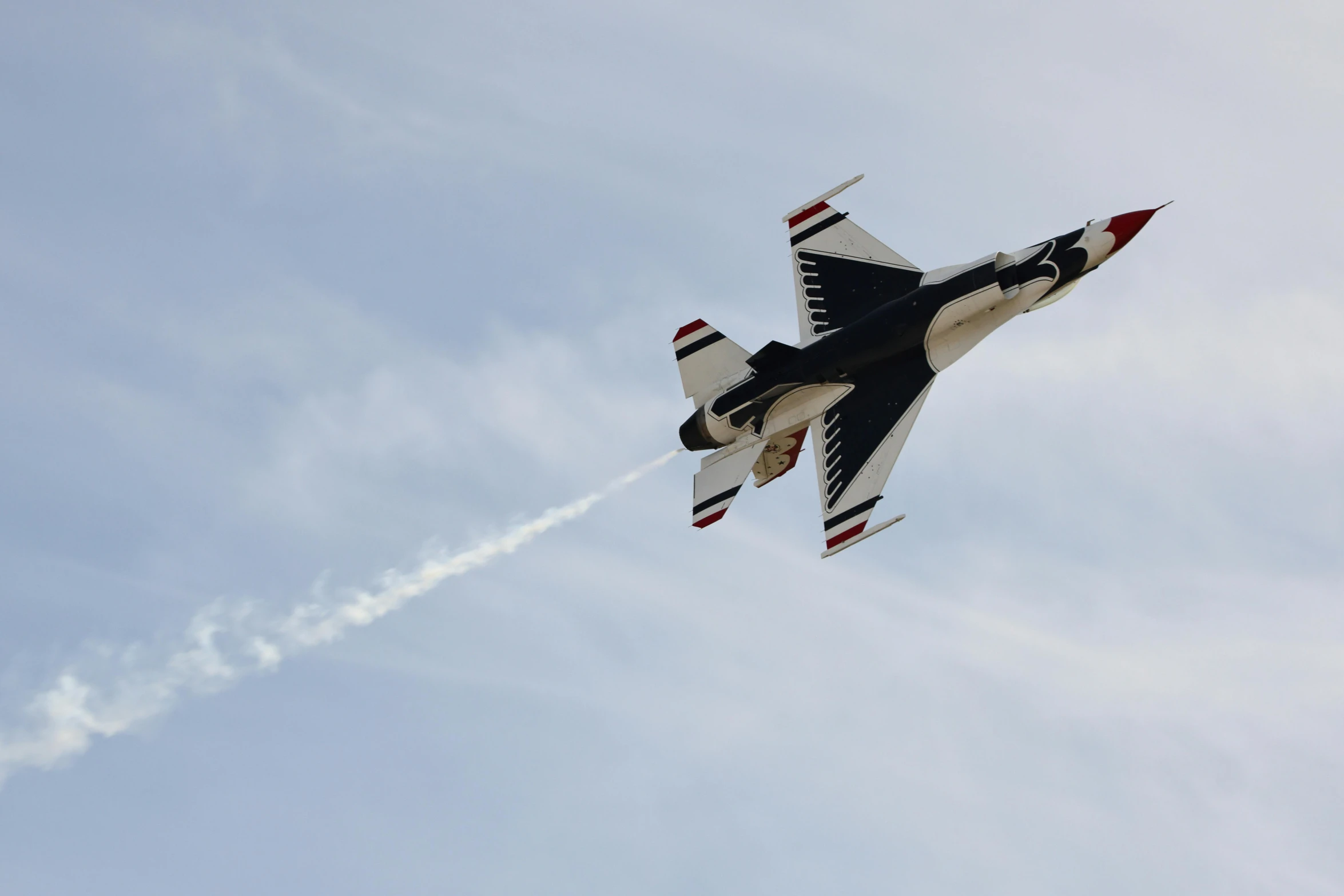 a fighter jet in a cloudy sky