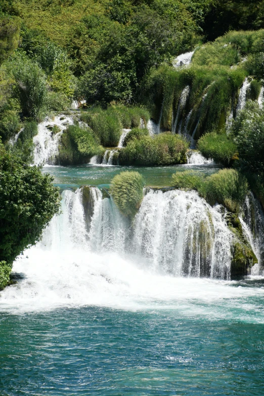 the waterfall is flowing water from the trees