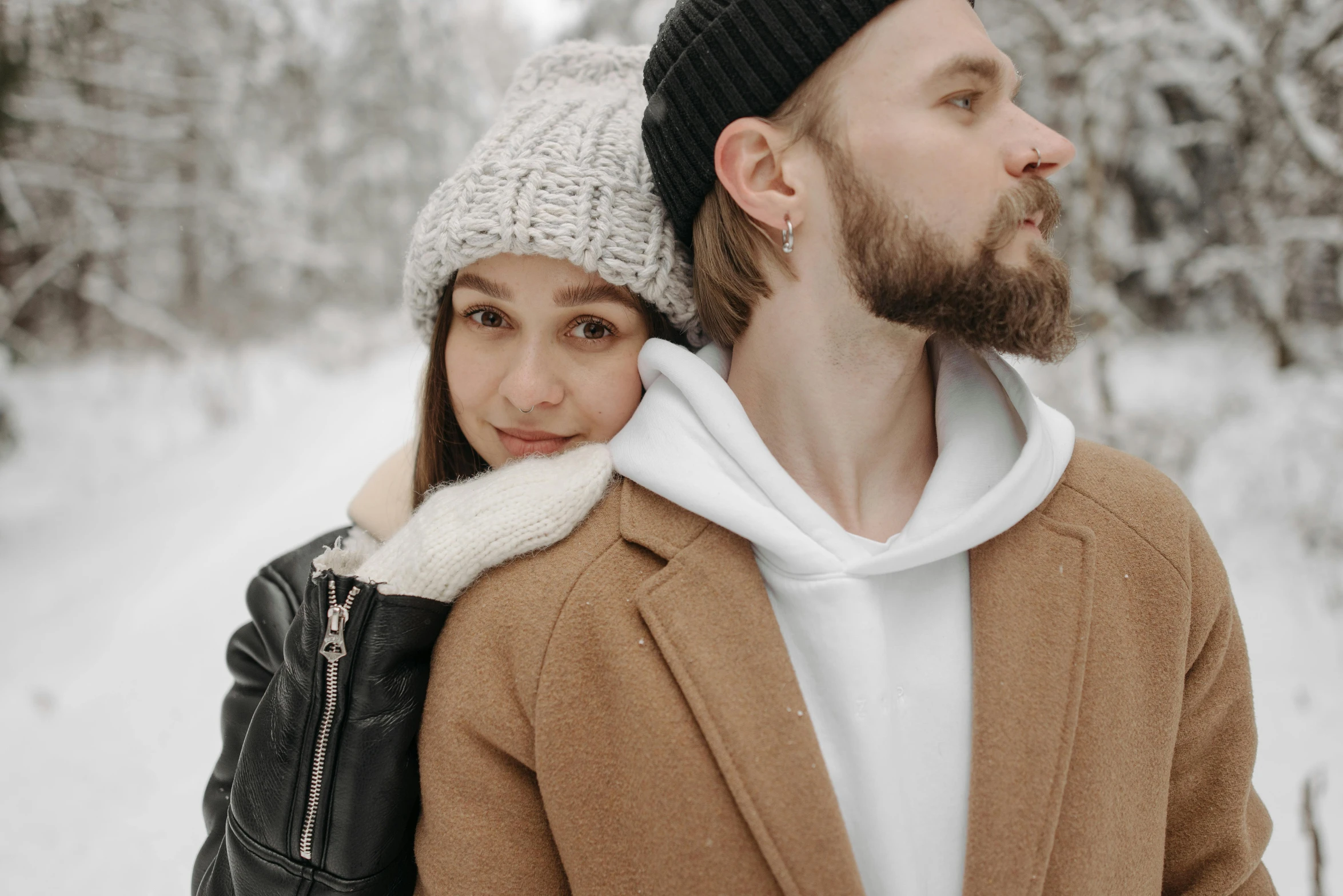 a man and a woman in winter wear stand together