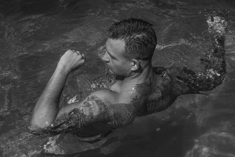 a man swimming with his hand on his hip