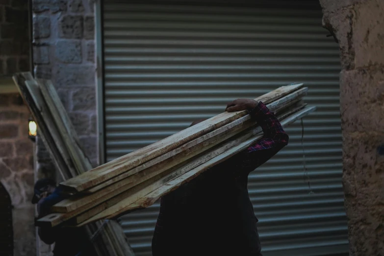 the woman holds up wooden boards in her hands