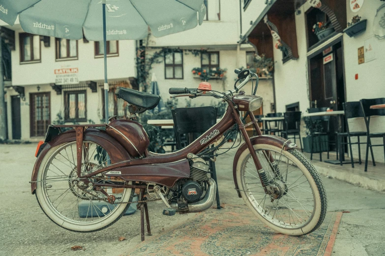 a brown motorbike parked outside in the rain