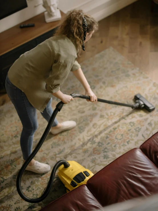  using yellow vacuum in living room