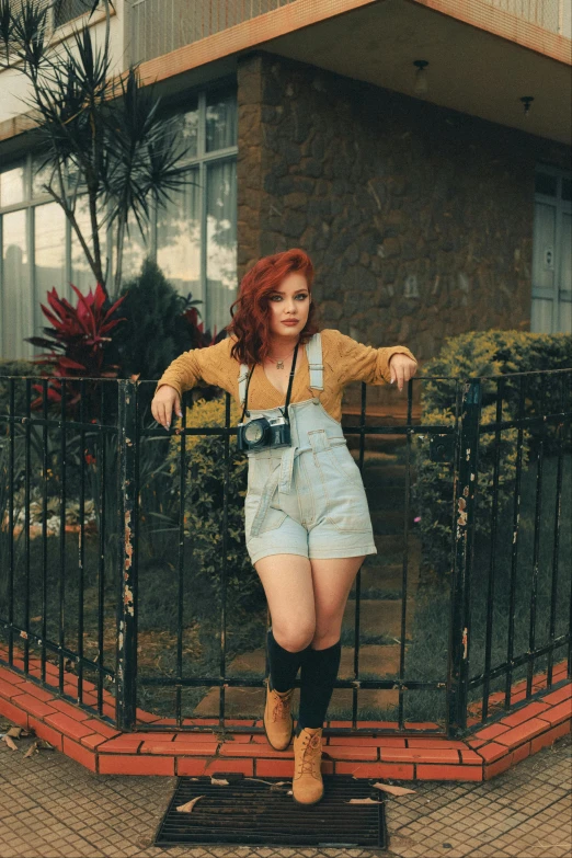 a woman standing in front of a black iron fence